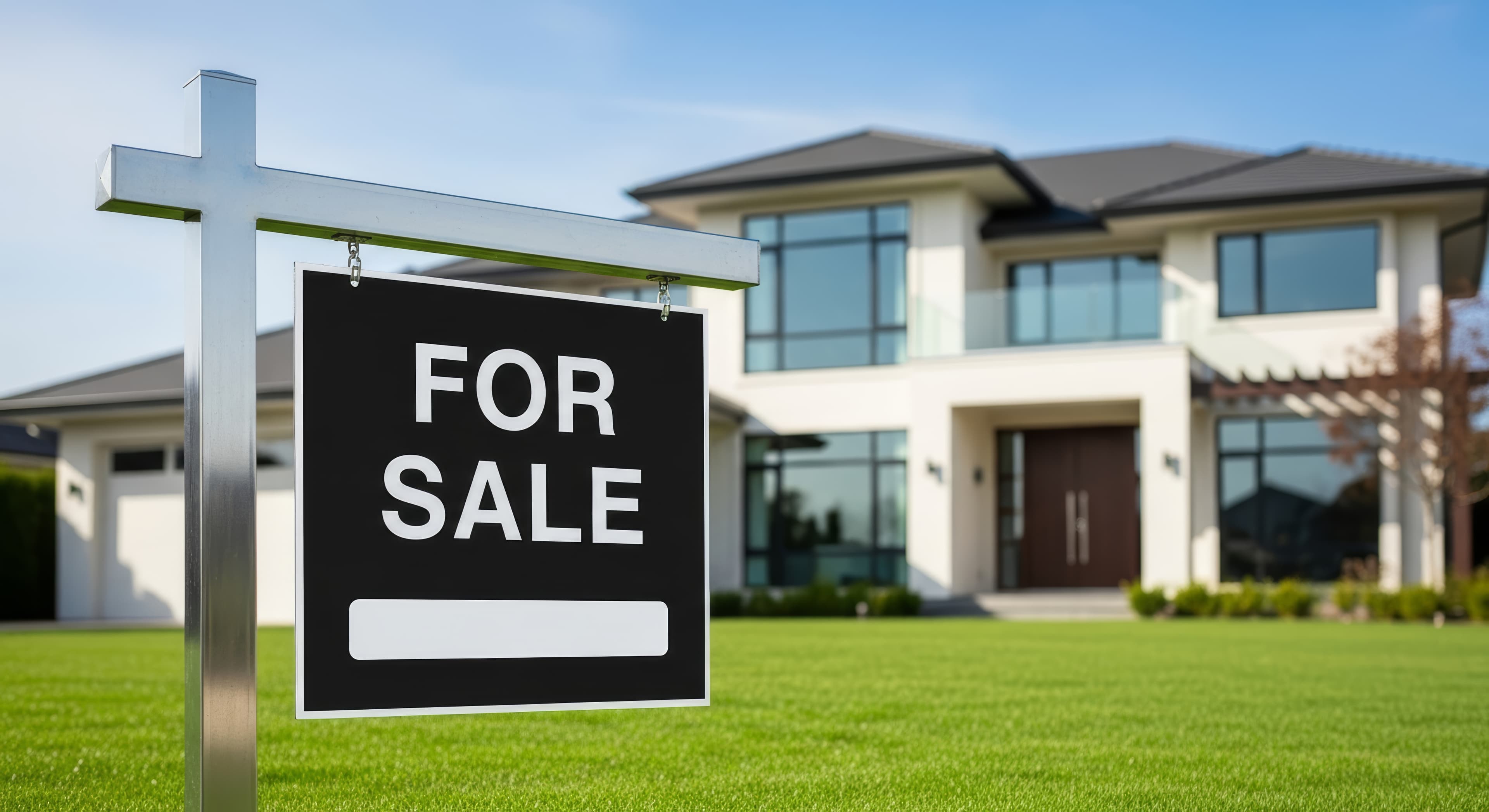 Modern home with a for sale sign on the lawn
